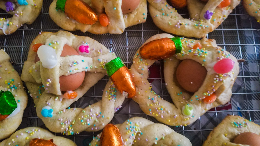 Sicilian cuddure decorated with choolates and sprinkle on a cookie rack.