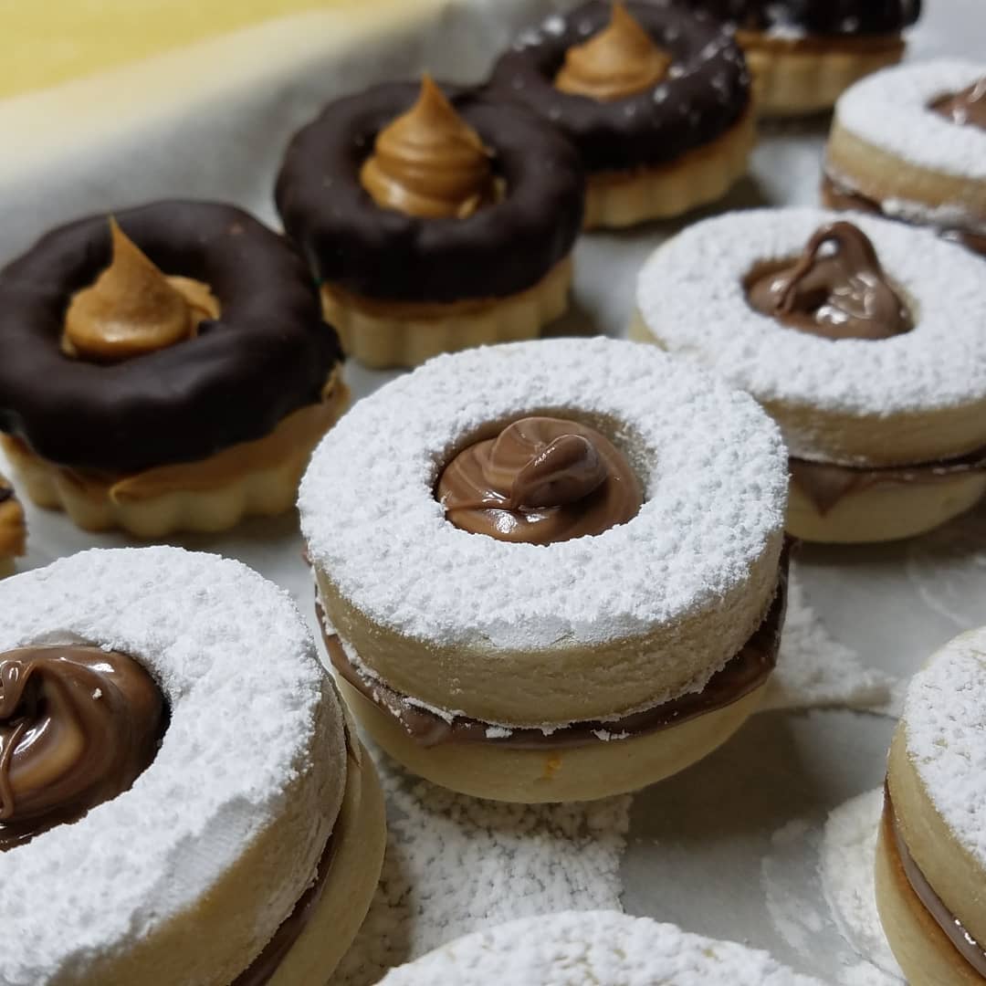 La vita è bella Bakery occhi di bue with nutella and peanut butter on a dish.