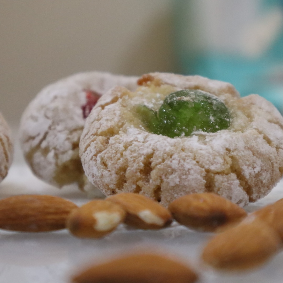 Authentic Sicilian almond paste cookie on the table with almonds and blury background.