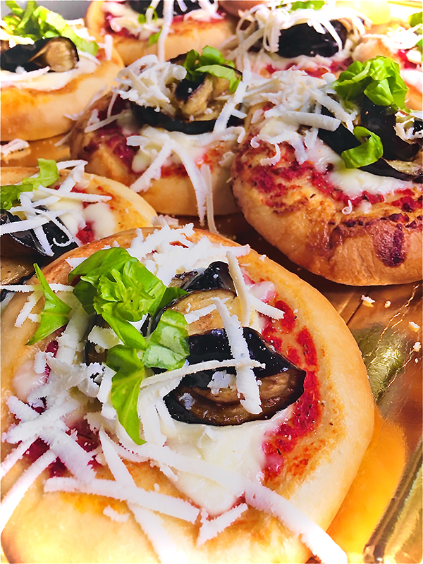 Sicilian mini pizzas for parties plain mozzarella and cheese and eggplant.
